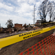 Tape warning of the dangers of asbestos in the air around older homes destroyed by fire in Tathra, Australia on March 23, 2018.